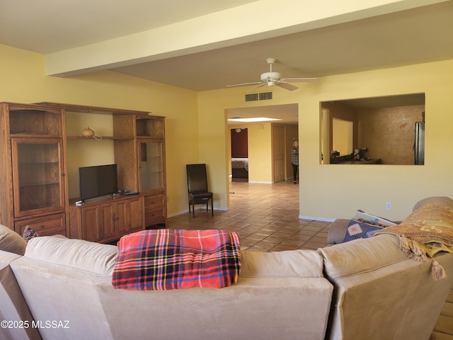 living room featuring tile patterned flooring, beamed ceiling, and ceiling fan