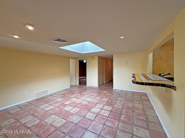 8034 E Shadow Ln, Tucson, AZ 85750 - spare room featuring a skylight, baseboards, and recessed lighting