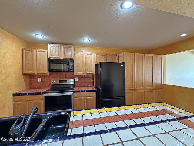 8034 E Shadow Ln, Tucson, AZ 85750 - kitchen featuring black appliances, tile countertops, light brown cabinetry, recessed lighting, and a textured ceiling