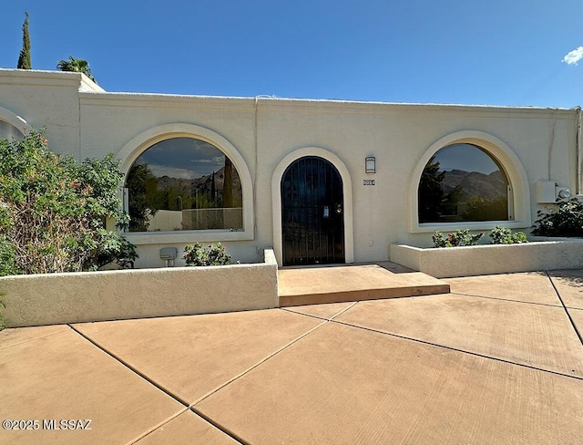 8034 E Shadow Ln, Tucson, AZ 85750 - property entrance with stucco siding and a patio