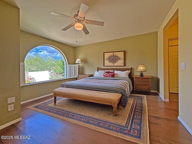8034 E Shadow Ln, Tucson, AZ 85750 - bedroom featuring wood finished floors, baseboards, and a ceiling fan