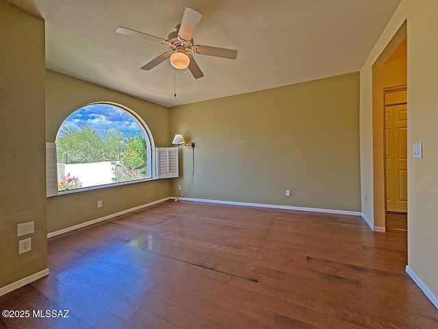 8034 E Shadow Ln, Tucson, AZ 85750 - empty room with hardwood / wood-style flooring, ceiling fan, and baseboards