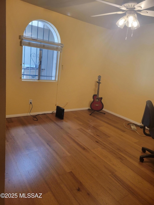 spare room with hardwood / wood-style flooring and ceiling fan