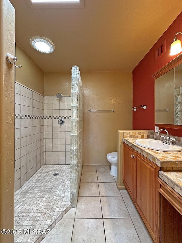 8034 E Shadow Ln, Tucson, AZ 85750 - full bath with tile patterned flooring, vanity, walk in shower, and toilet