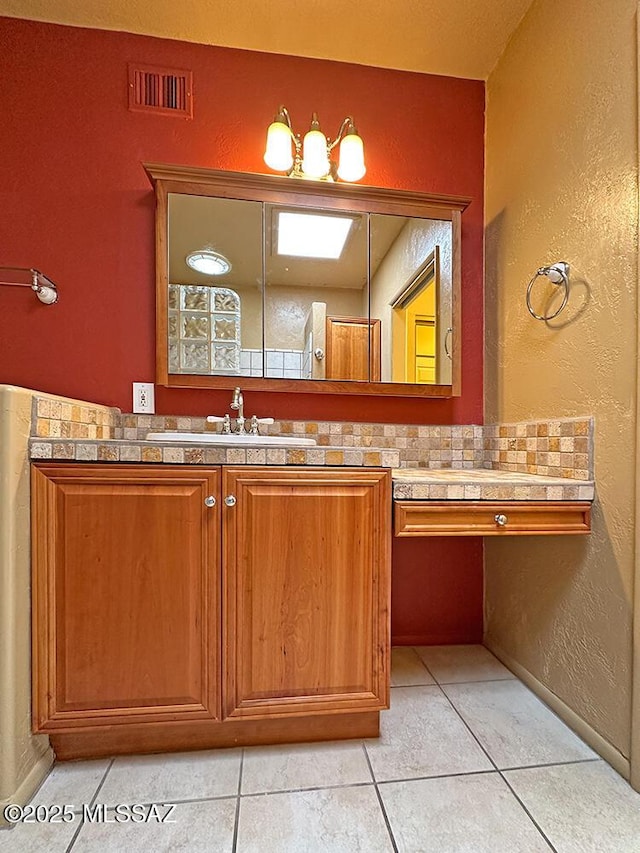 8034 E Shadow Ln, Tucson, AZ 85750 - bathroom with tile patterned floors, vanity, and a textured wall