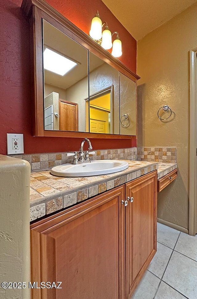 8034 E Shadow Ln, Tucson, AZ 85750 - bathroom featuring tile patterned floors, a textured wall, and vanity