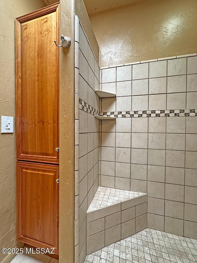 8034 E Shadow Ln, Tucson, AZ 85750 - full bath featuring a textured wall and tiled shower