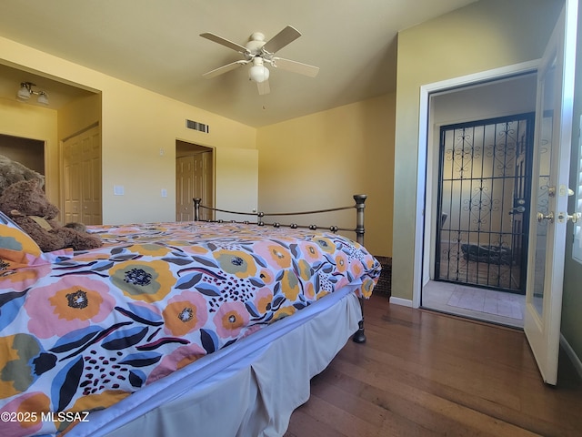 bedroom with dark wood-type flooring, ceiling fan, and vaulted ceiling