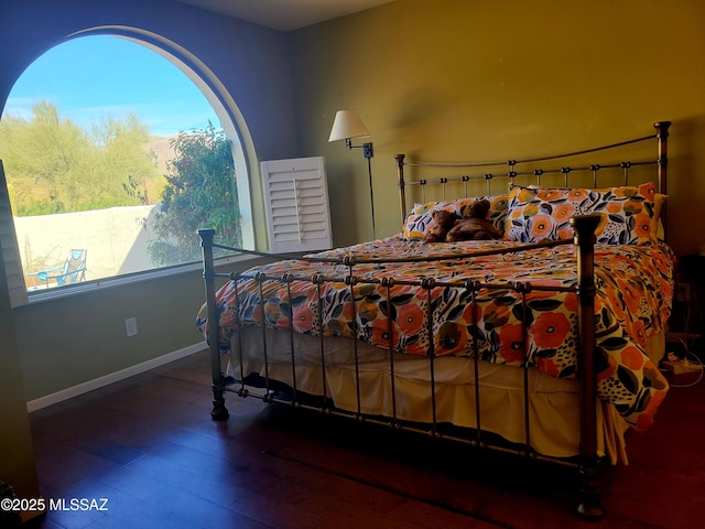 bedroom with dark hardwood / wood-style floors