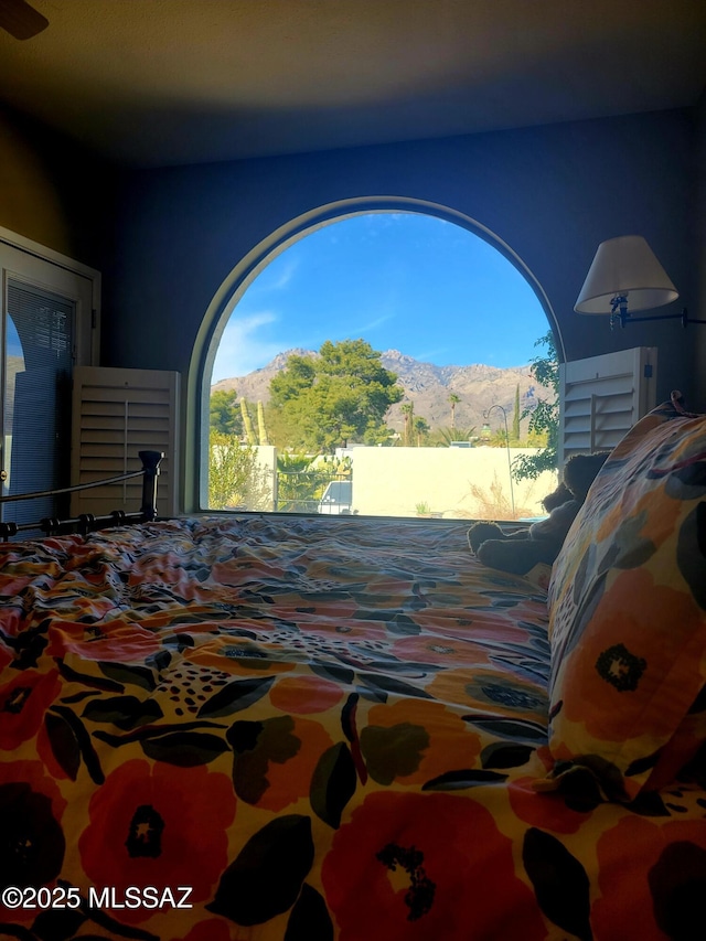 bedroom featuring a mountain view