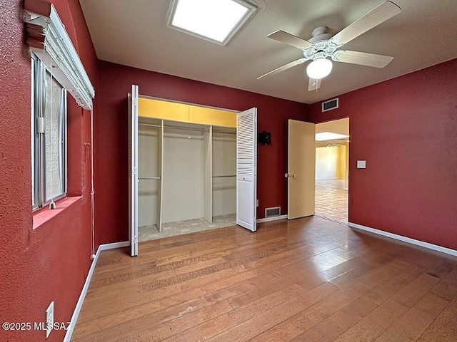 8034 E Shadow Ln, Tucson, AZ 85750 - unfurnished bedroom with baseboards, light wood-type flooring, a closet, and a ceiling fan