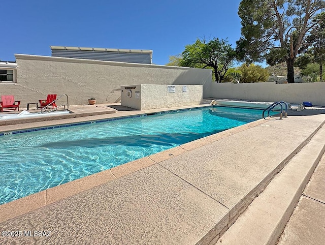 8034 E Shadow Ln, Tucson, AZ 85750 - community pool with a patio area and a fenced backyard