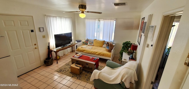 tiled living room featuring ceiling fan