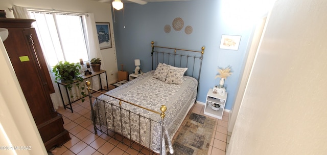 bedroom featuring tile patterned floors and ceiling fan