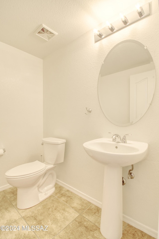 bathroom with tile patterned floors, toilet, and sink