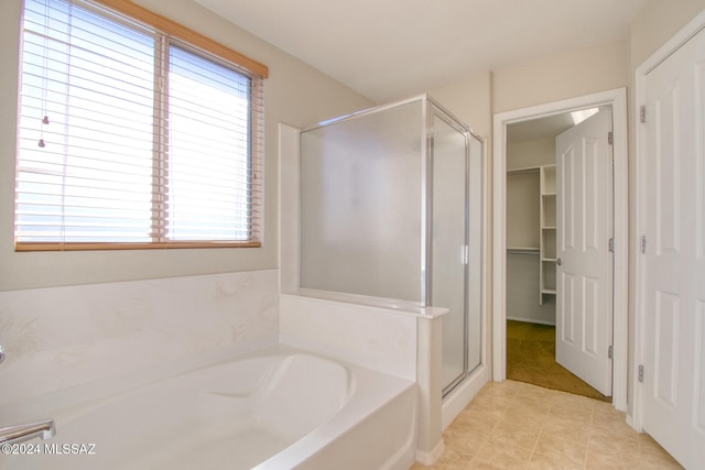 bathroom with tile patterned floors, a healthy amount of sunlight, and separate shower and tub