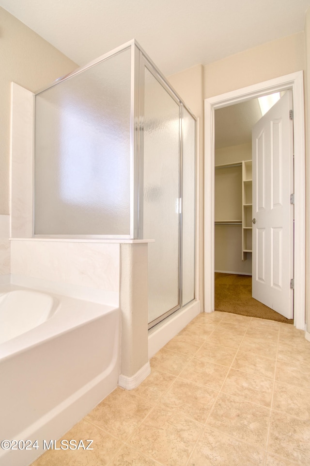 bathroom featuring separate shower and tub and tile patterned flooring