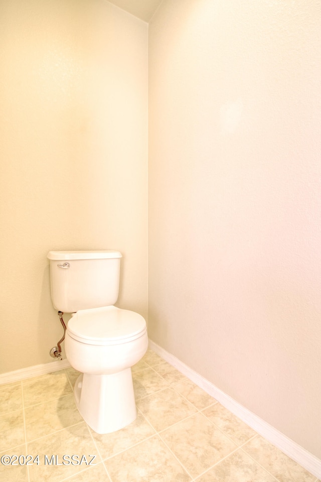 bathroom with tile patterned floors and toilet