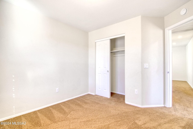 unfurnished bedroom with a closet and carpet