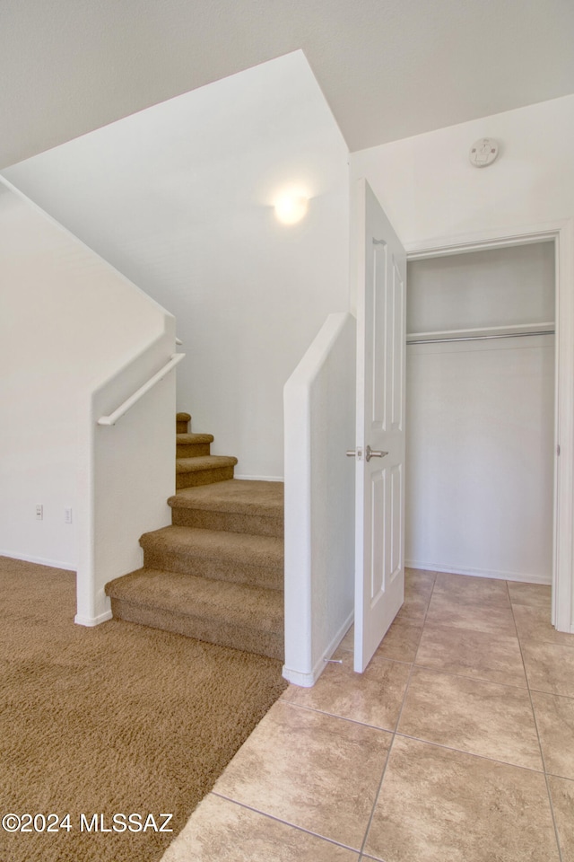 stairway featuring tile patterned flooring