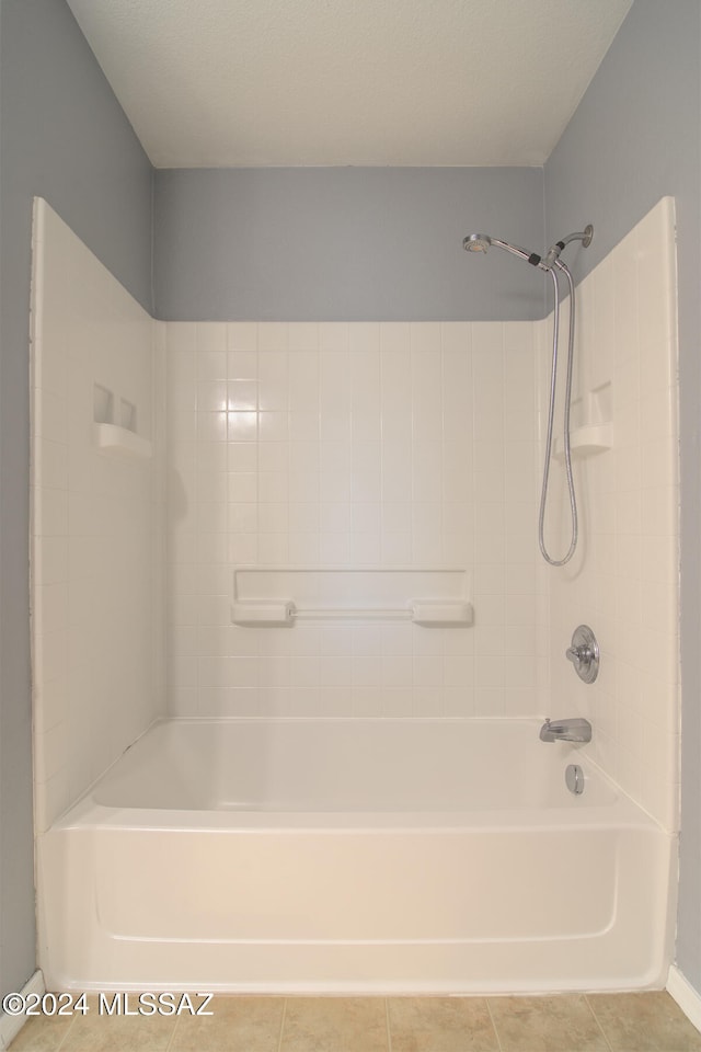 bathroom with tile patterned flooring and washtub / shower combination