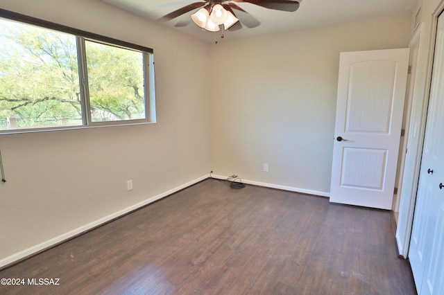 unfurnished room featuring ceiling fan and dark hardwood / wood-style flooring