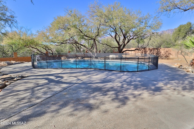 view of swimming pool with a patio area