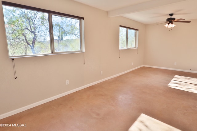 carpeted spare room with a wealth of natural light, beamed ceiling, and ceiling fan