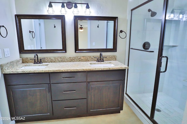 bathroom featuring vanity and a shower with door