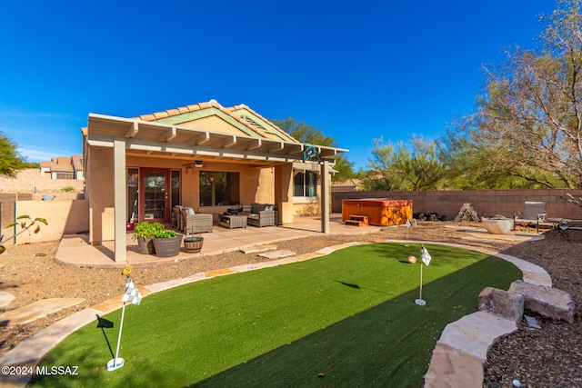 rear view of property with outdoor lounge area, a patio, a hot tub, and ceiling fan