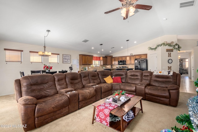 carpeted living room with ceiling fan with notable chandelier and lofted ceiling