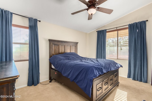 bedroom with ceiling fan, light colored carpet, and lofted ceiling