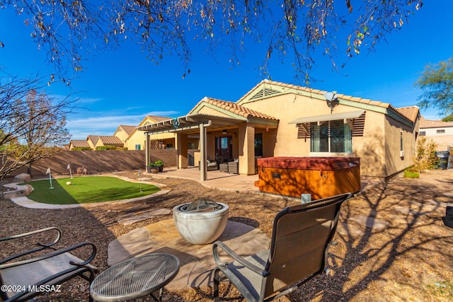 13696 E Aviara Pl, Vail, AZ 85641 - back of property with a putting green, a patio, stucco siding, a tiled roof, and a hot tub