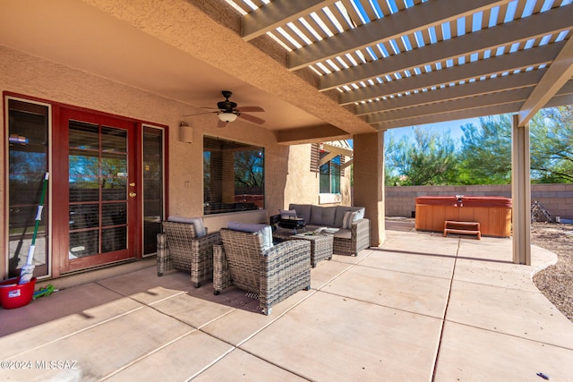 view of patio with an outdoor living space, ceiling fan, a pergola, and a hot tub