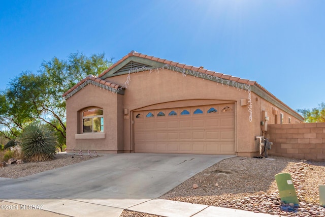 13696 E Aviara Pl, Vail, AZ 85641 - mediterranean / spanish house featuring an attached garage, driveway, stucco siding, and a tile roof