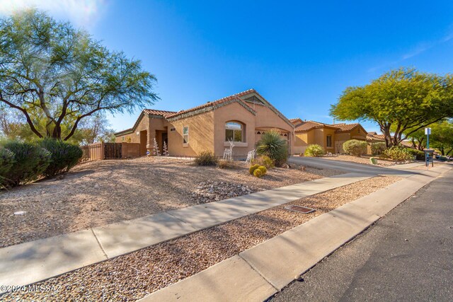 13696 E Aviara Pl, Vail, AZ 85641 - mediterranean / spanish-style house featuring stucco siding, driveway, a tile roof, and a garage
