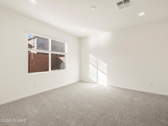 spare room with recessed lighting, visible vents, a wealth of natural light, and carpet flooring
