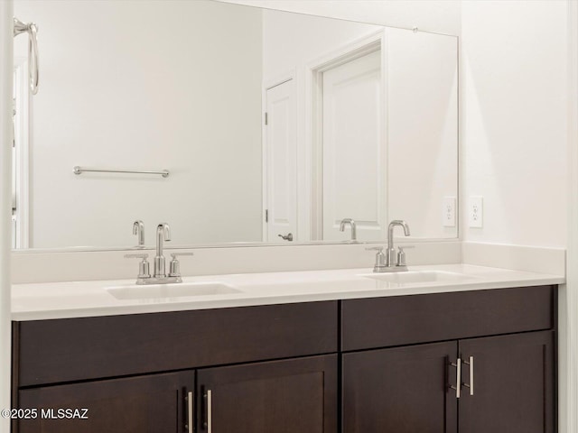 full bathroom featuring double vanity and a sink