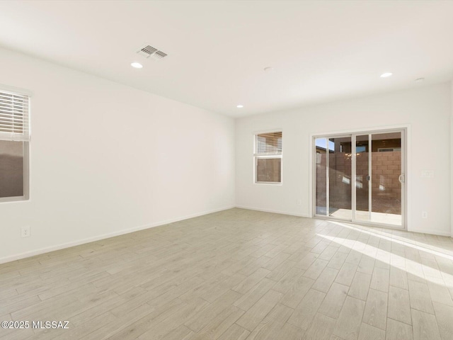 empty room featuring baseboards, recessed lighting, visible vents, and light wood-style floors