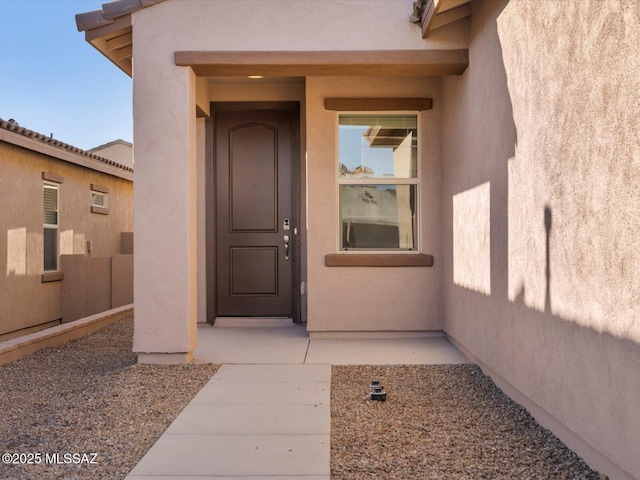 property entrance with stucco siding