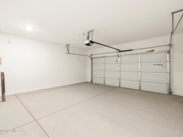 garage with baseboards and a garage door opener