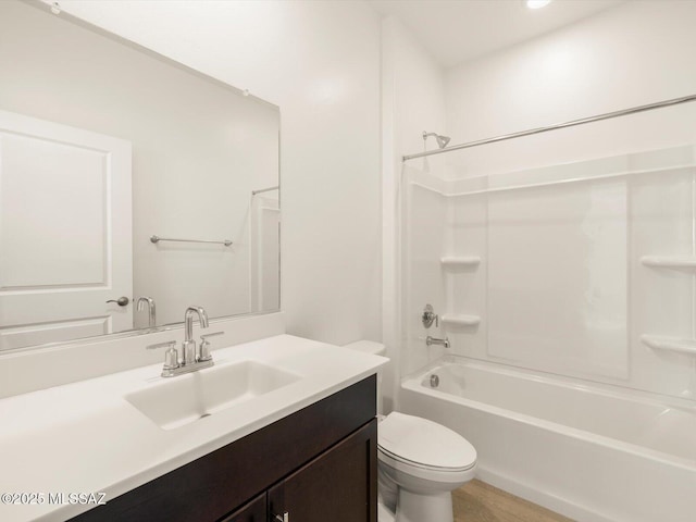 bathroom with bathing tub / shower combination, vanity, and toilet