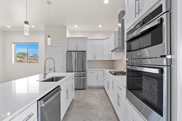 kitchen with light stone counters, sink, white cabinetry, and stainless steel appliances