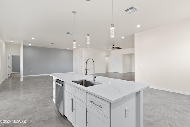 kitchen featuring a kitchen island with sink, white cabinets, hanging light fixtures, sink, and ceiling fan