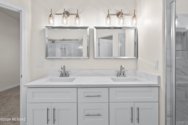 bathroom with vanity and a shower with door