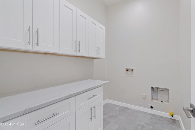 clothes washing area with electric dryer hookup, gas dryer hookup, hookup for a washing machine, and cabinets