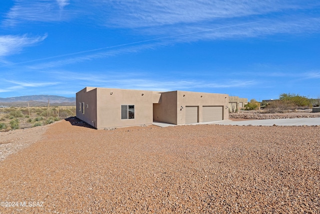 southwest-style home with a mountain view and a garage