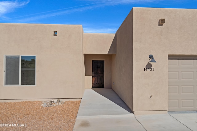 view of exterior entry with a garage