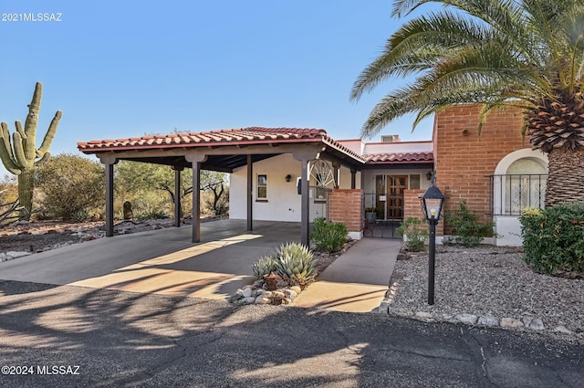 611 S Los Opalos, Green Valley, AZ 85614 - view of front of home featuring a tiled roof, stucco siding, an attached carport, and concrete driveway