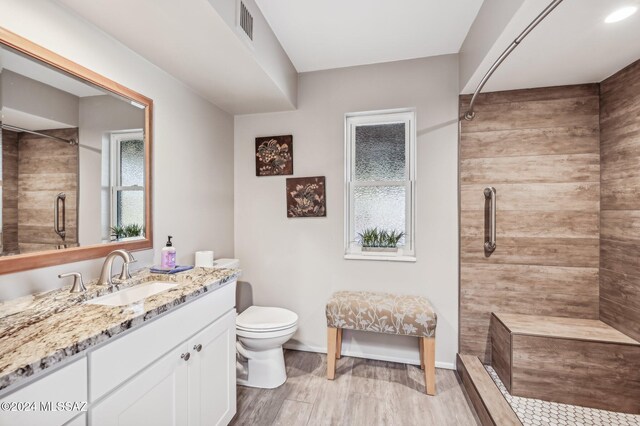 611 S Los Opalos, Green Valley, AZ 85614 - bathroom with tiled shower, toilet, vanity, and healthy amount of natural light